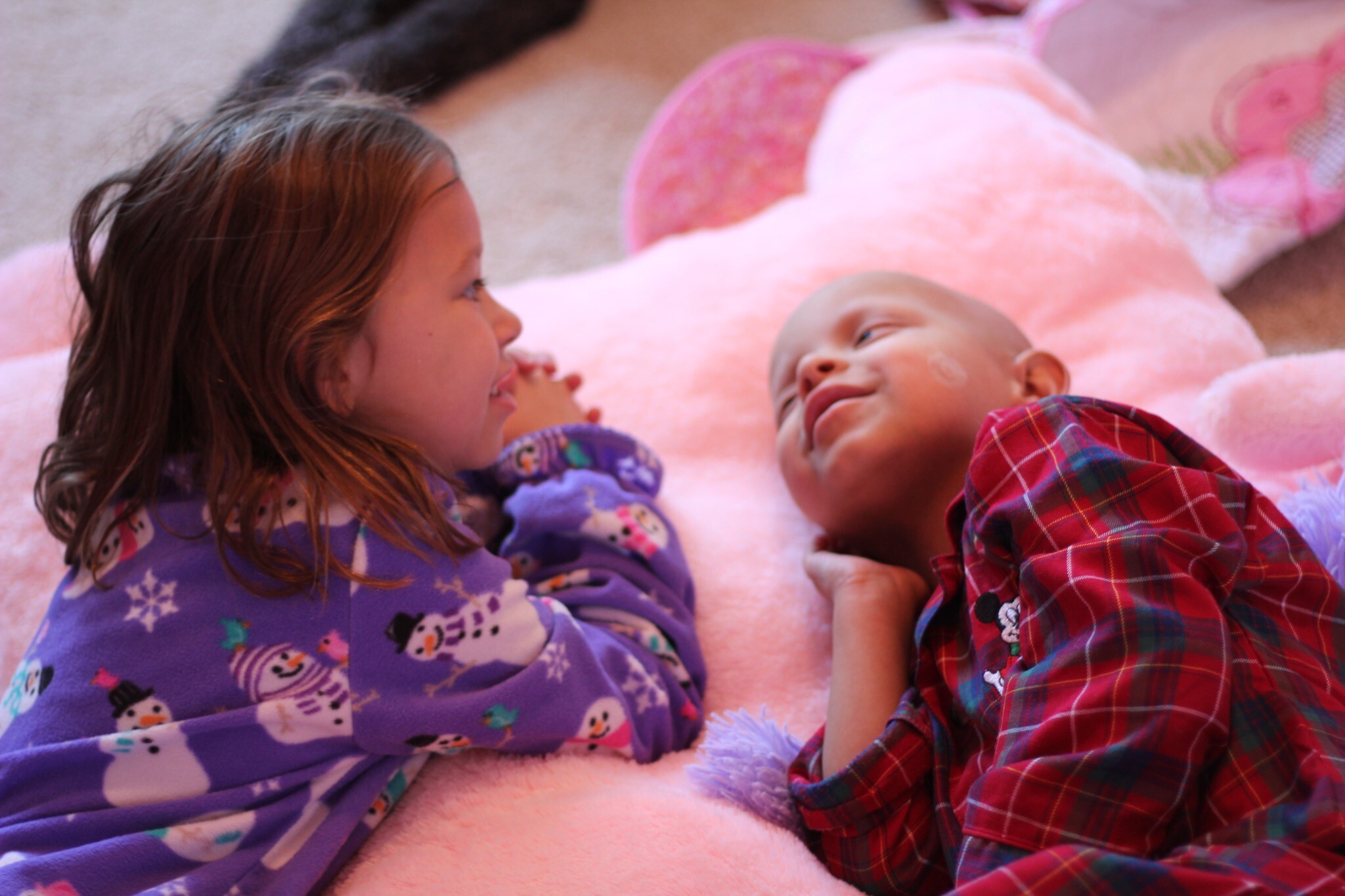 Young Emma and Chase looking at each other